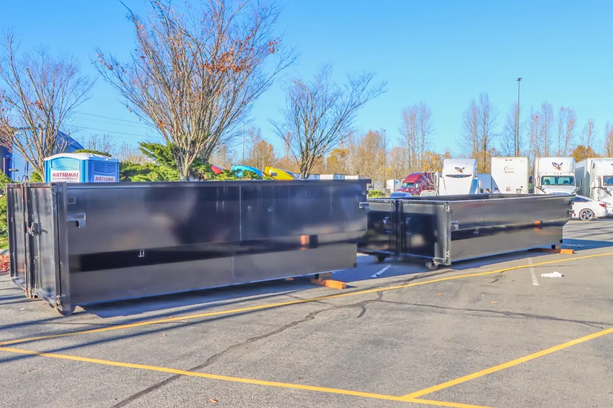 Professional dumpster rental service with roll-off container on residential driveway in Titusville